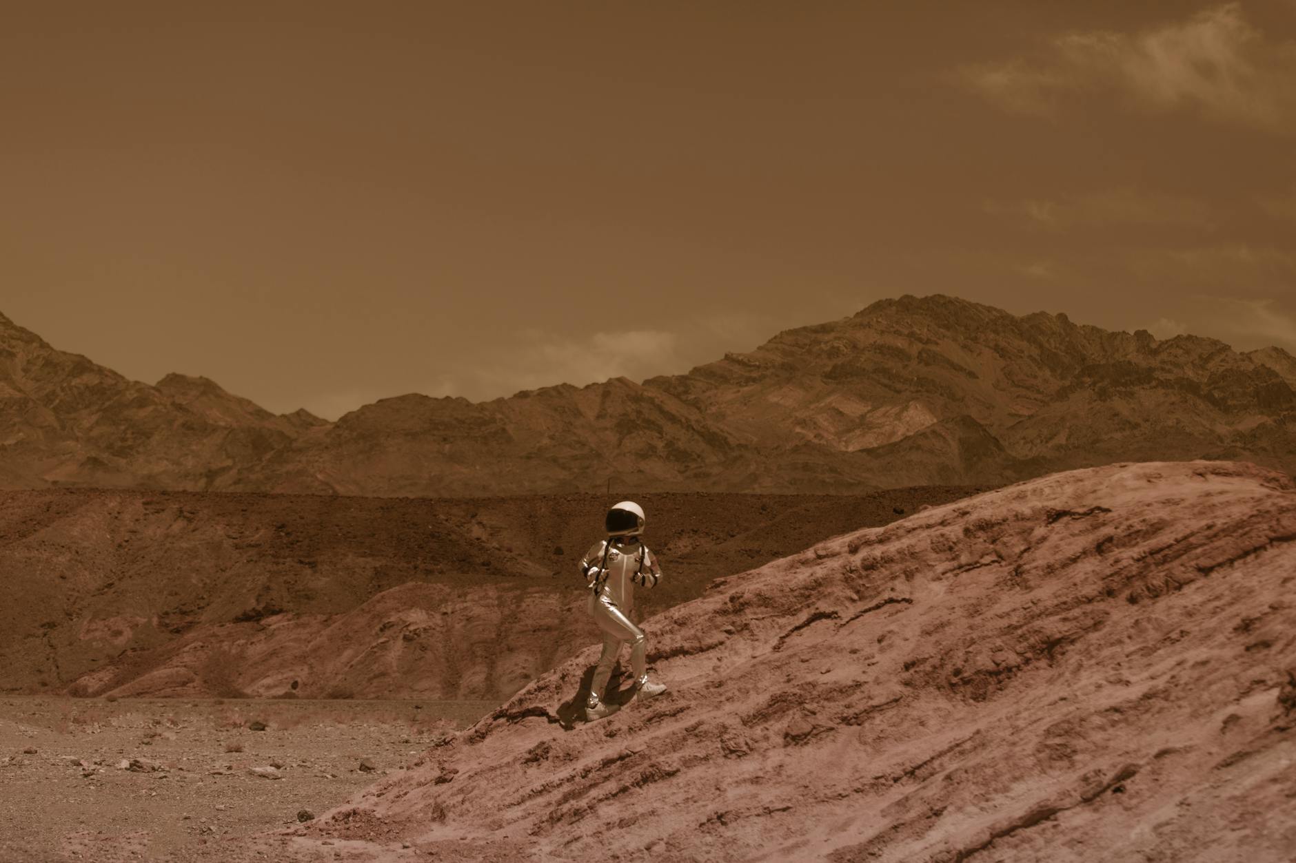 astronaut in a spacesuit walking on mars surface