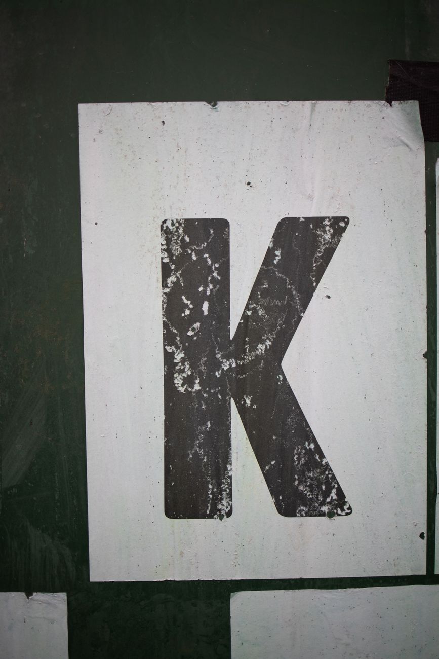 scratched letter k stack to the wall